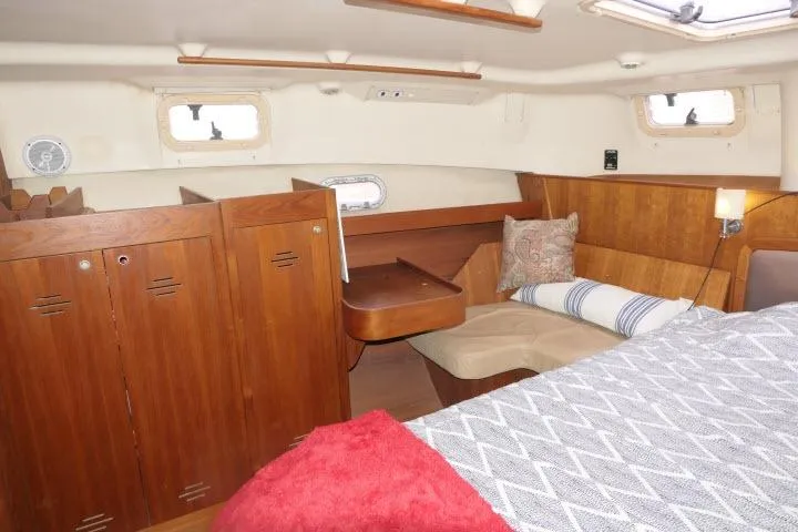 Slide: The Image of Interior of 1999 Hunter 450 Passage yacht with wooden cabinetry and cozy seating area. - 42