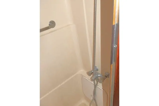Slide: The Image of Shower area in 1999 Hunter 450 Passage boat, featuring a handheld showerhead. - 45
