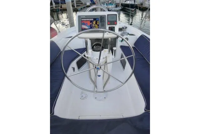 Slide: The Image of Cockpit of 1999 Hunter 450 Passage sailboat with steering wheel and navigation instruments. - 52