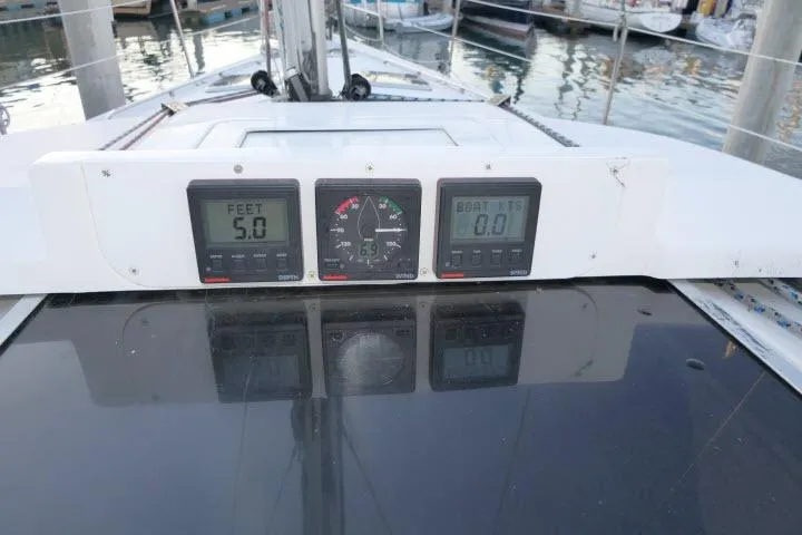 Slide: The Image of Hunter 450 Passage 1999 sailboat dashboard with depth and speed gauges at marina. - 55