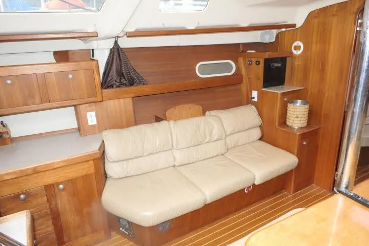 Slide: The Image of Interior of 1999 Hunter 450 Passage yacht with beige leather sofa and wooden cabinetry. - 7