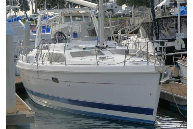Slide: The Image of 1999 Hunter 450 Passage sailboat docked in a marina, featuring sleek design and spacious deck. - 71