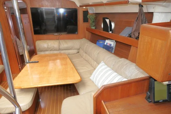 Slide: The Image of Interior of 1999 Hunter 450 Passage yacht with cozy seating and wooden finishes. - 9