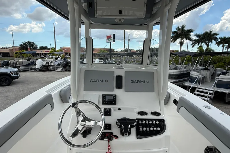 Slide: The Image of 2021 NauticStar 28 XS Offshore boat dashboard with Garmin navigation system. - 11