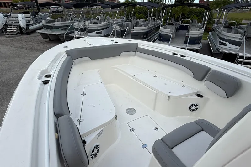 Slide: The Image of 2021 NauticStar 28 XS Offshore boat with spacious seating and storage, docked among other boats. - 13