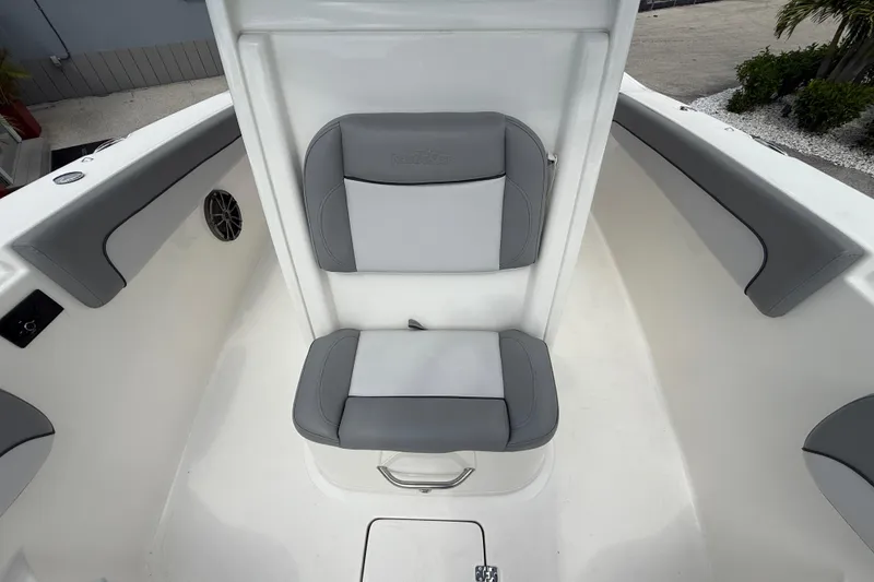 Slide: The Image of 2021 NauticStar 28 XS Offshore boat seating area with gray cushions. - 19