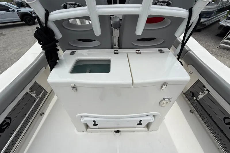 Slide: The Image of 2021 NauticStar 28 XS Offshore boat interior with storage compartment and seating. - 20