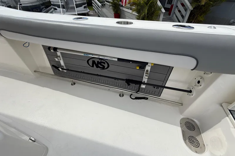 Slide: The Image of 2021 NauticStar 28 XS Offshore boat interior with fishing rod holder and storage. - 21