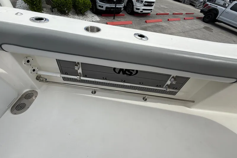 Slide: The Image of 2021 NauticStar 28 XS Offshore boat interior with measuring scale and rod holders. - 23