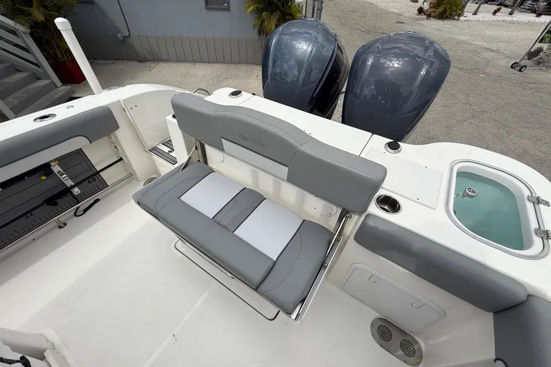 Slide: The Image of 2021 NauticStar 28 XS Offshore boat interior with seating and dual engines. - 24