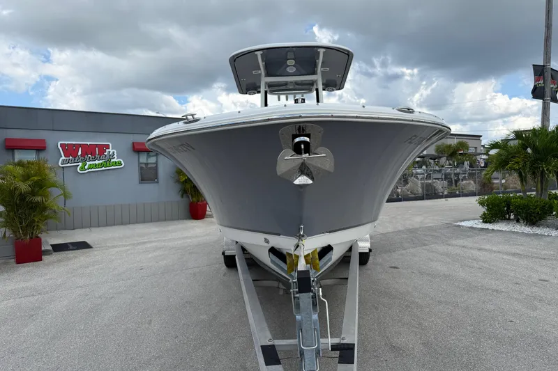 Slide: The Image of 2021 NauticStar 28 XS Offshore boat on trailer at dealership, cloudy sky background. - 4