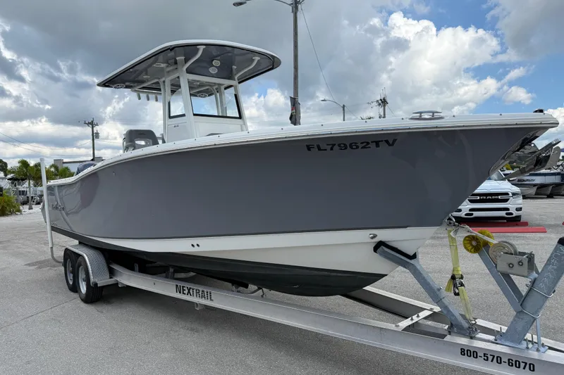 Slide: The Image of 2021 NauticStar 28 XS Offshore boat on trailer under cloudy sky. - 5