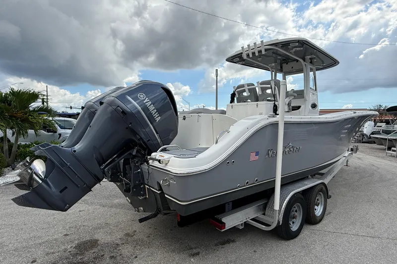 Slide: The Image of 2021 NauticStar 28 XS Offshore boat with Yamaha engine on trailer under cloudy sky. - 6