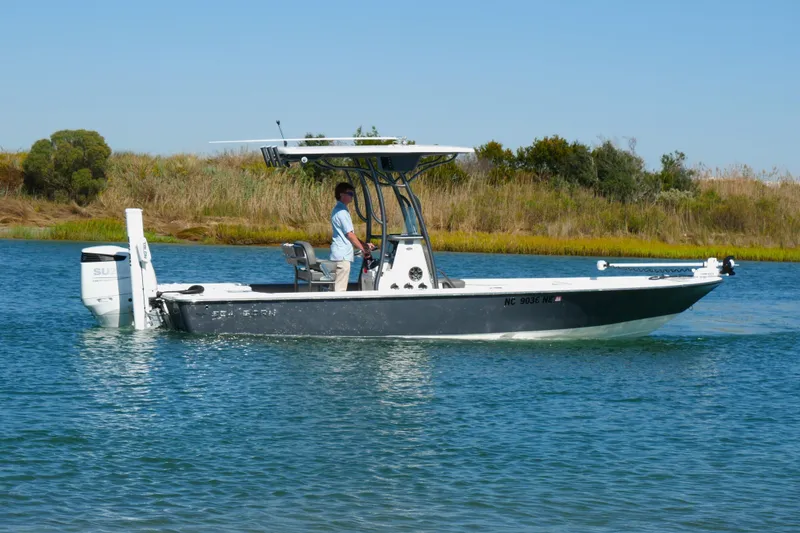 Slide: The Image of 2023 Sea Born FX24 Bay boat cruising on a calm waterway. - 1