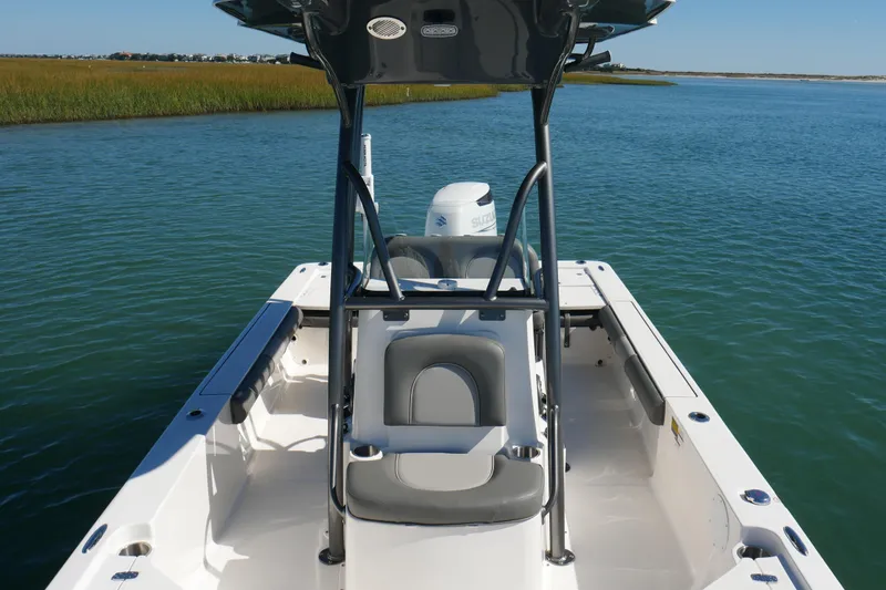 Slide: The Image of 2023 Sea Born FX24 Bay boat on calm water, featuring sleek design and spacious deck. - 13