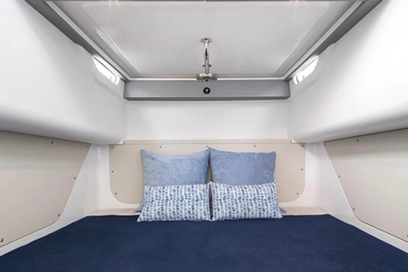 Slide: The Image of Interior cabin of 2026 Cruisers Yachts 38 VTR with blue bedding and pillows. - 11