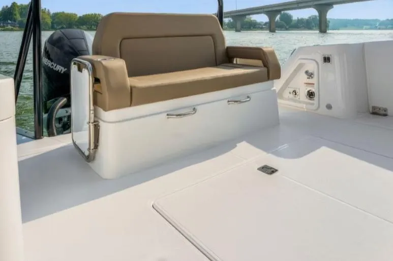 Slide: The Image of 2026 Cruisers Yachts 38 VTR interior with tan seating, overlooking a scenic waterway. - 18