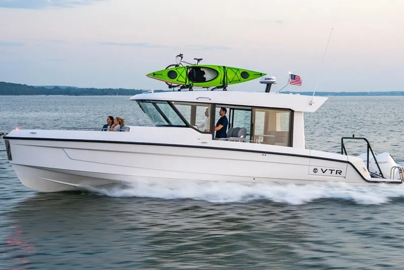 The Image of 2026 Cruisers Yachts 38 VTR cruising on water with kayak on roof. - 0