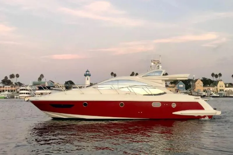 The Image of 2007 Azimut 43S yacht with red hull, docked at sunset. - 0