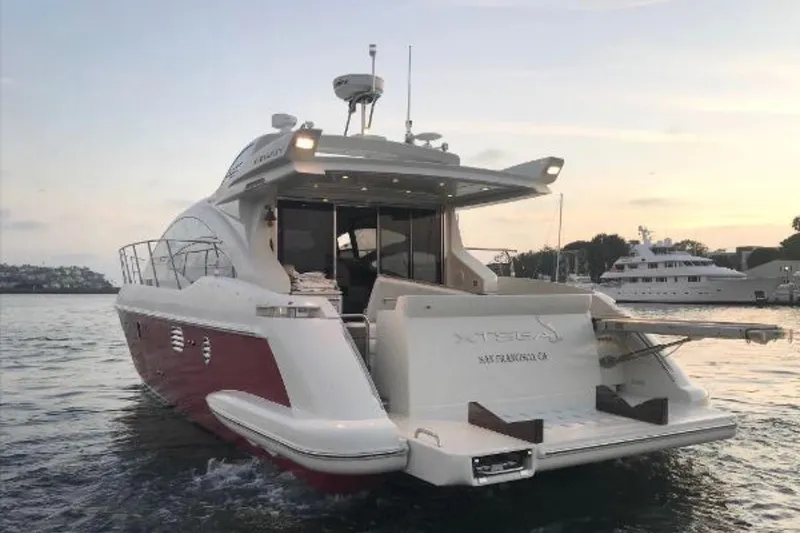 Slide: The Image of 2007 Azimut 43S yacht on water at sunset, showcasing sleek design and luxury features. - 1