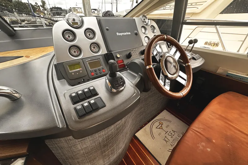 Slide: The Image of 2007 Azimut 43S yacht helm with Raymarine navigation and wooden steering wheel. - 15