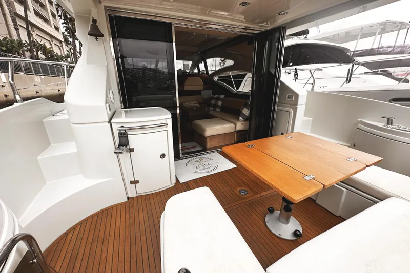 Slide: The Image of 2007 Azimut 43S yacht interior with wooden deck and seating area. - 2