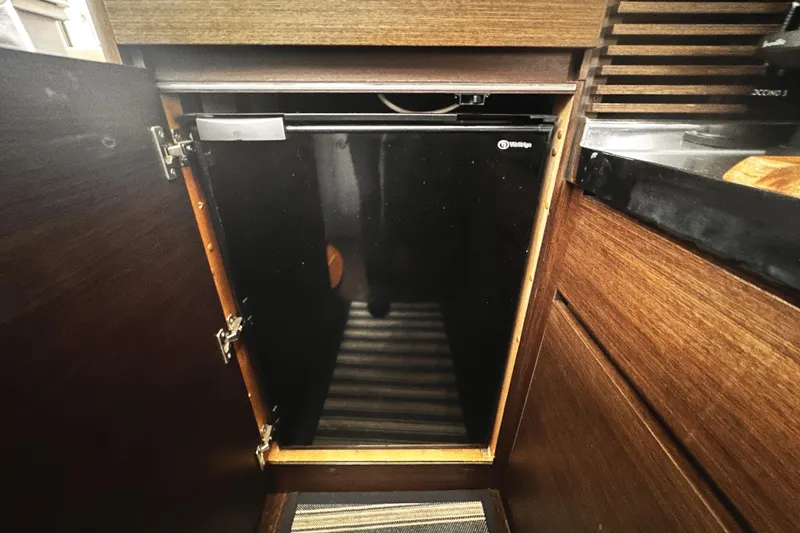 Slide: The Image of Small fridge inside 2007 Azimut 43S yacht's wooden cabinet. - 25