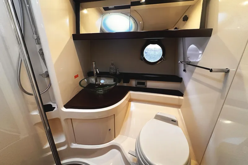Slide: The Image of Elegant wooden cabinet with neatly arranged teacups and saucers on a 2007 Azimut 43S yacht. - 28