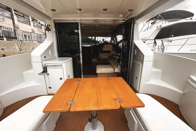 Slide: The Image of 2007 Azimut 43S yacht interior with wooden table and seating area. - 3
