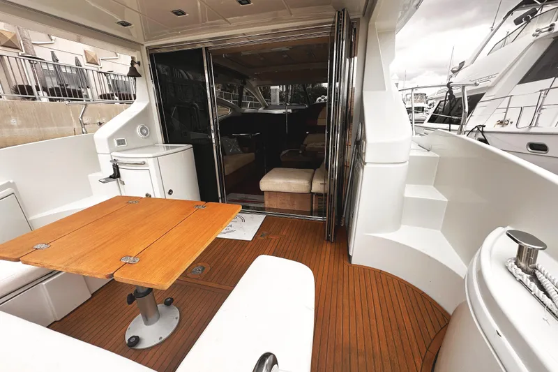 Slide: The Image of Luxurious 2007 Azimut 43S yacht interior with wooden deck and seating area. - 4