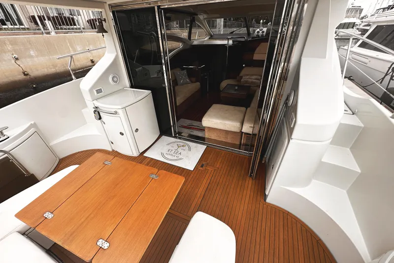 Slide: The Image of Luxurious 2007 Azimut 43S yacht interior with wooden deck and modern seating area. - 6