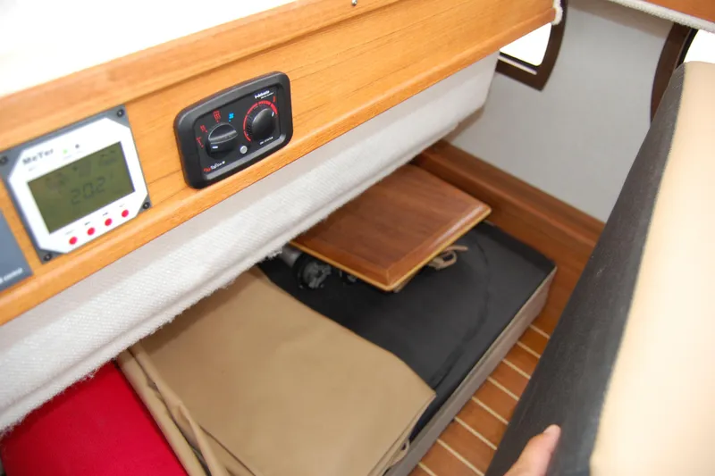 Slide: The Image of 2018 Ranger Tugs R29 interior storage with control panels and wooden flooring. - 15