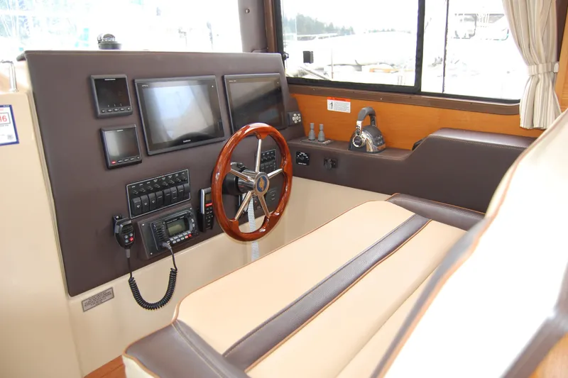 Slide: The Image of 2018 Ranger Tugs R29 helm with modern navigation equipment and comfortable seating. - 19