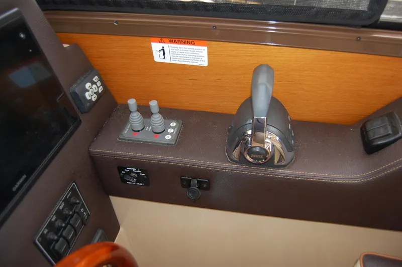 Slide: The Image of Control panel of a 2018 Ranger Tugs R29 boat with joystick and throttle. - 21