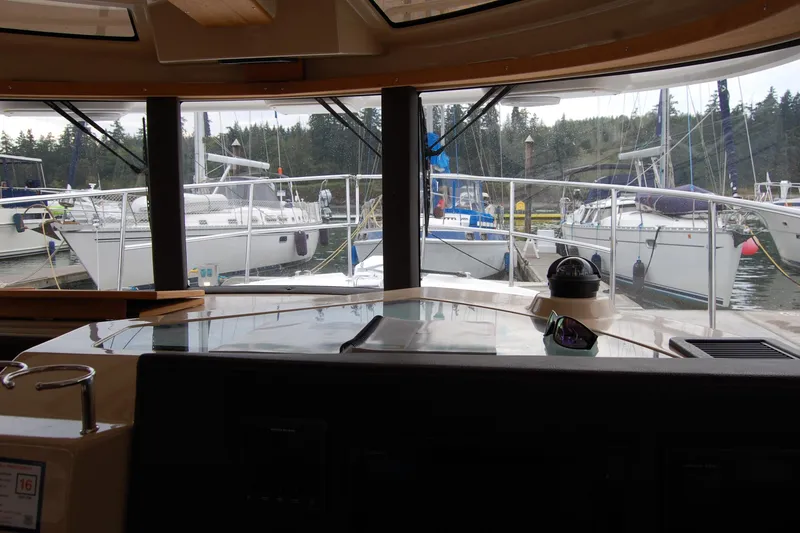 Slide: The Image of Interior view from 2018 Ranger Tugs R29, overlooking marina with docked sailboats. - 24