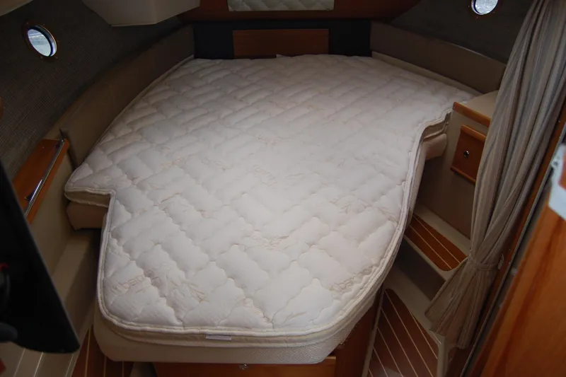 Slide: The Image of 2018 Ranger Tugs R29 cabin interior with a cozy bed setup. - 30
