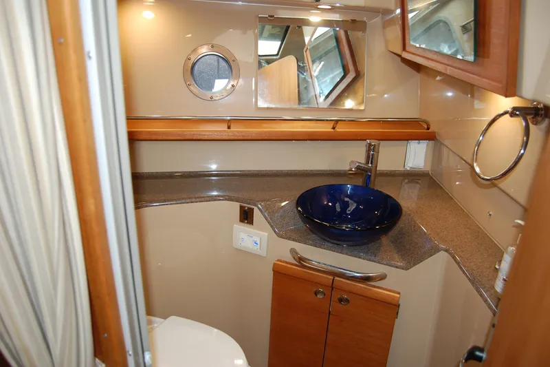 Slide: The Image of 2018 Ranger Tugs R29 bathroom with modern sink and porthole window. - 31