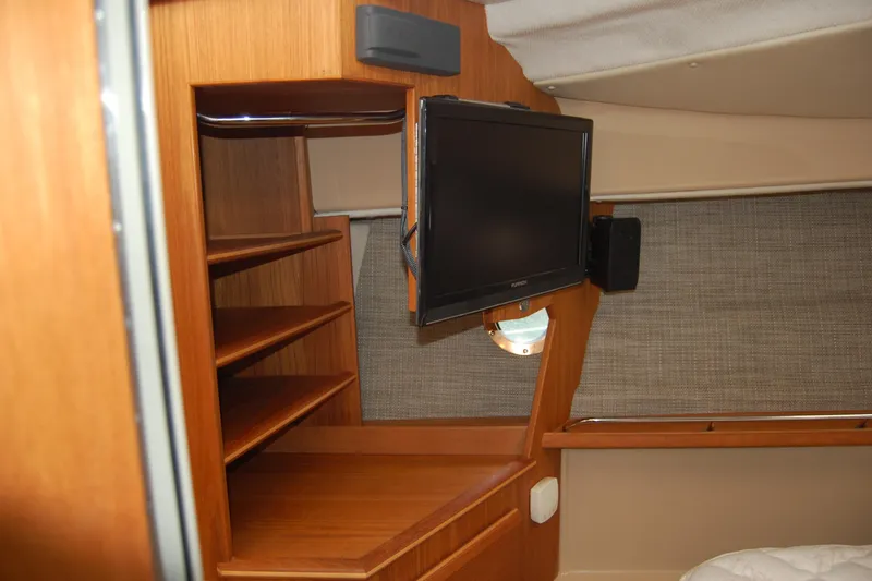 Slide: The Image of 2018 Ranger Tugs R29 interior with TV and wooden shelving. - 34