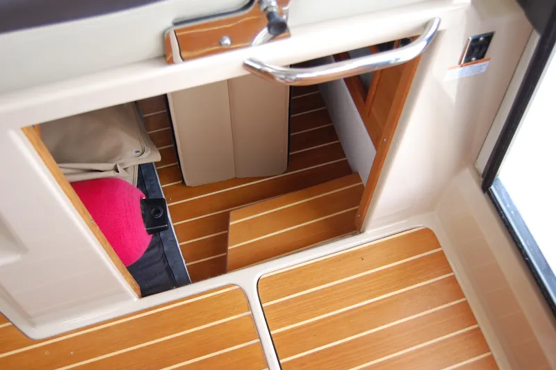 Slide: The Image of Interior view of 2018 Ranger Tugs R29 boat with wooden flooring and compact storage. - 38