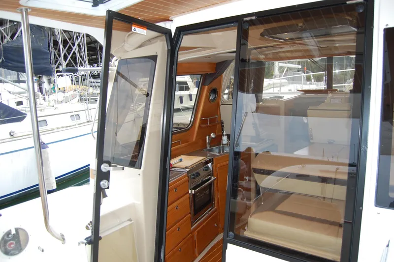 Slide: The Image of Interior view of 2018 Ranger Tugs R29, showcasing kitchen and seating area. - 42