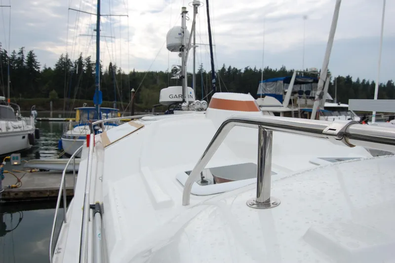 Slide: The Image of 2018 Ranger Tugs R29 boat docked, featuring sleek design and stainless steel railings. - 44
