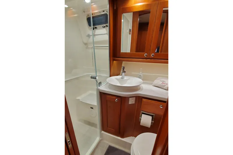 Slide: The Image of Cozy bedroom interior of 2021 Sabre 45 Salon Express yacht with wooden accents. - 12