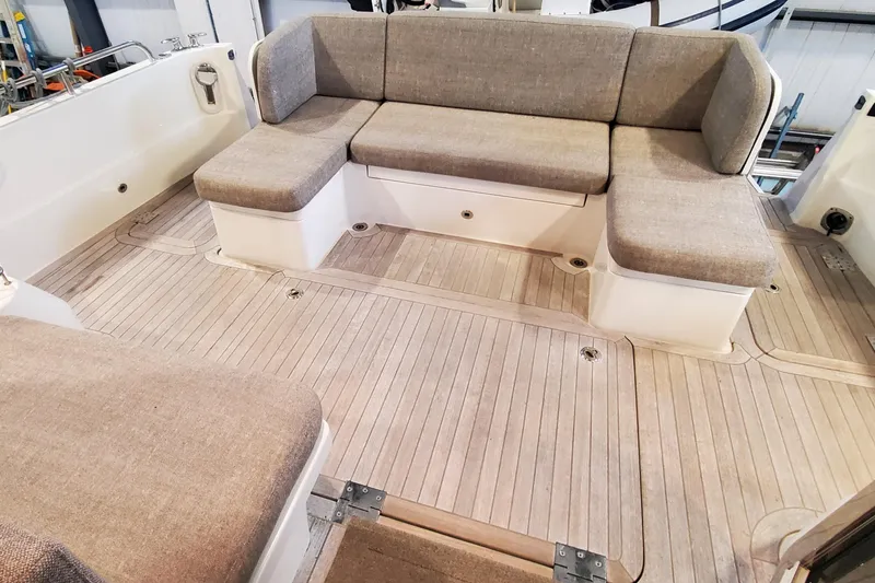 Slide: The Image of 2021 Sabre 45 Salon Express interior with beige seating and wooden flooring. - 22