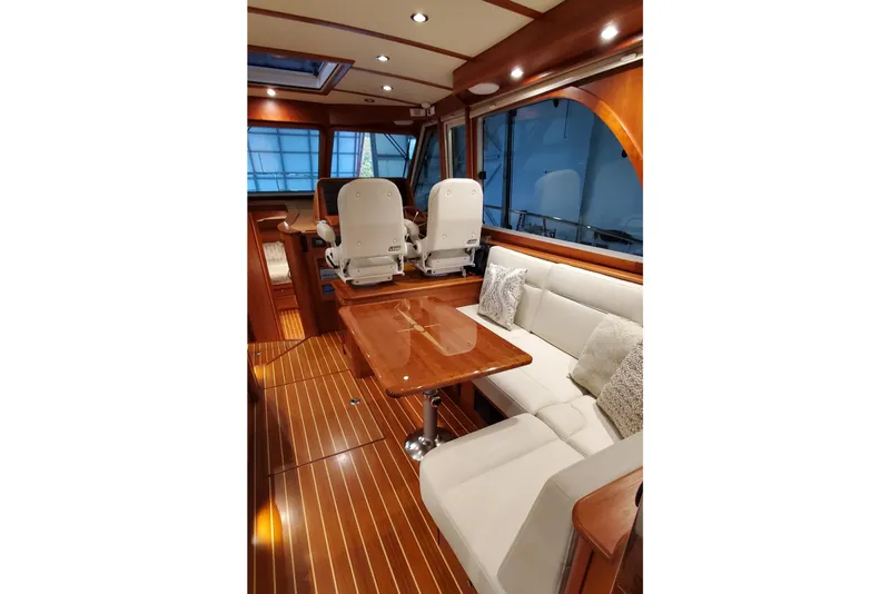 Slide: The Image of 2021 Sabre 45 Salon Express helm with navigation screens and wooden steering wheel. - 8