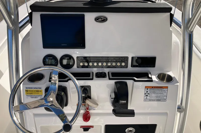Slide: The Image of 2024 Sea Fox 248 Commander helm with steering wheel, controls, and Garmin display. - 12