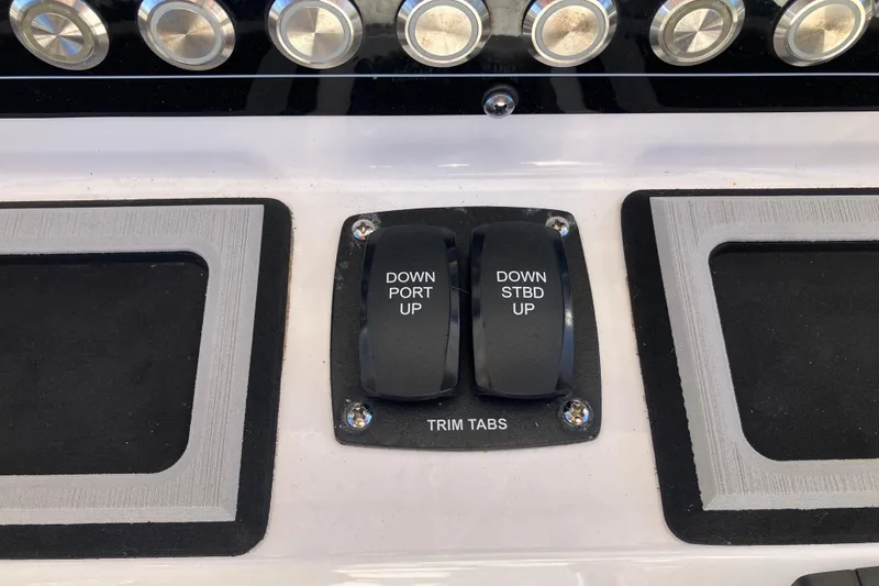 Slide: The Image of 2024 Sea Fox 248 Commander trim tab controls on dashboard. - 14