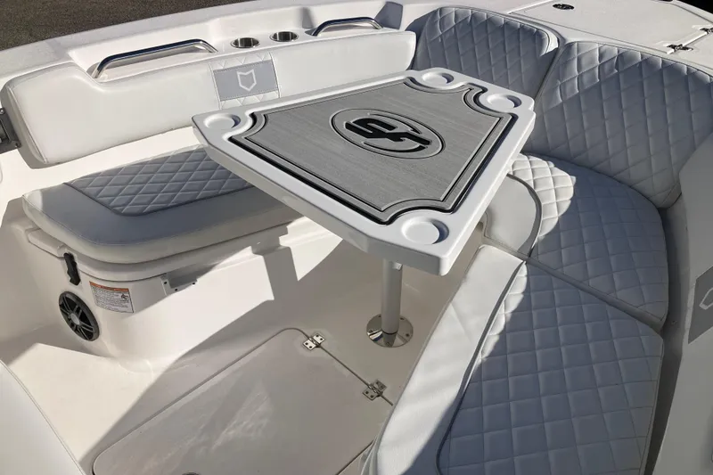 Slide: The Image of 2024 Sea Fox 248 Commander boat interior with cushioned seating and table. - 19