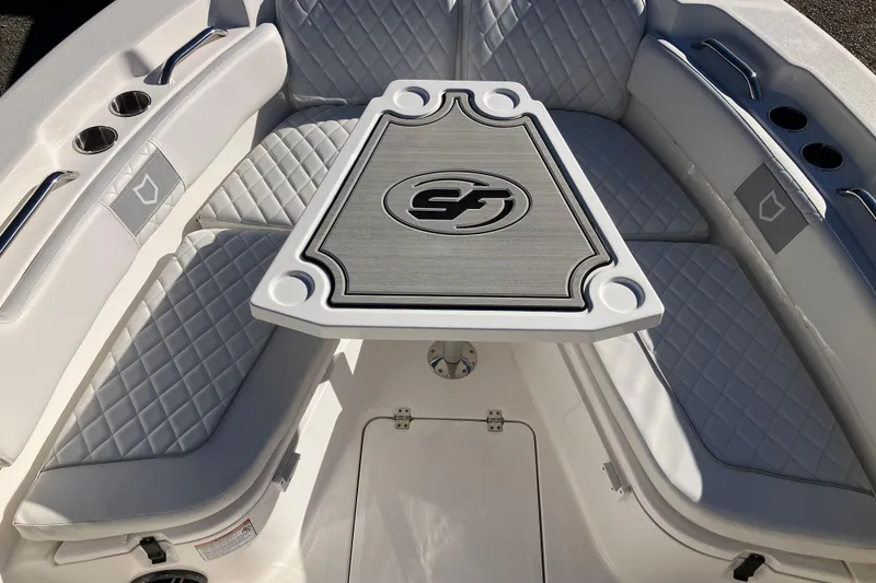 Slide: The Image of 2024 Sea Fox 248 Commander boat interior with quilted seating and central table. - 24