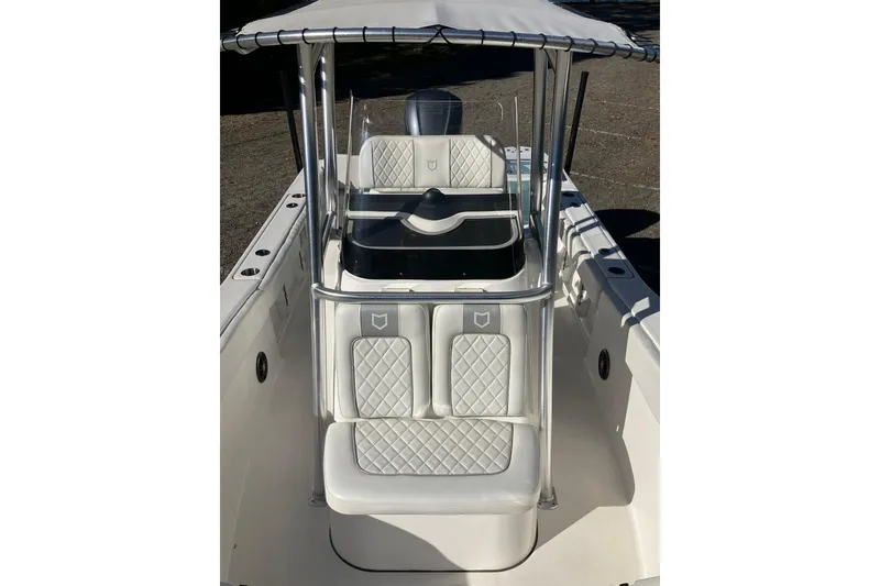 Slide: The Image of 2024 Sea Fox 248 Commander boat interior with cushioned seating and T-top canopy. - 29