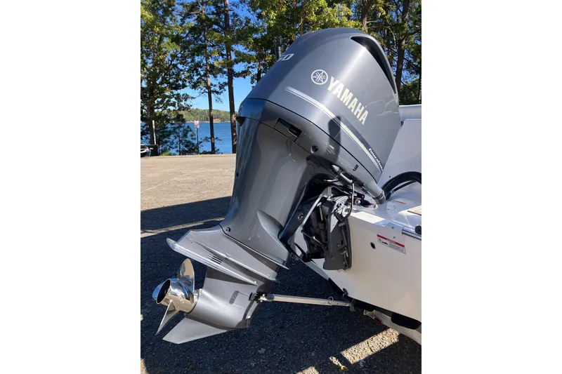 Slide: The Image of 2024 Sea Fox 248 Commander with Yamaha outboard motor, parked near a scenic lake. - 7